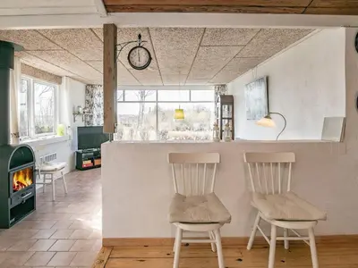 two chairs in a living room with a fireplace at 6 person holiday home in Farsø-By Traum in Farsø