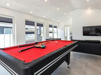 a billiard room with a red pool table at 10 person holiday home in Løkken-By Traum in Løkken