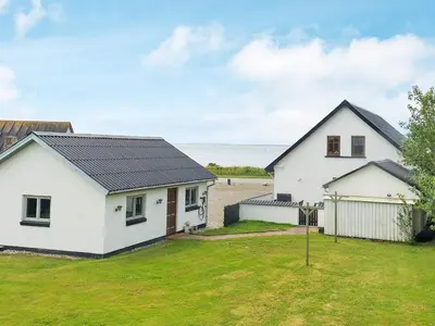 a white house with a black roof at 10 person holiday home in Vestervig-By Traum in Vestervig