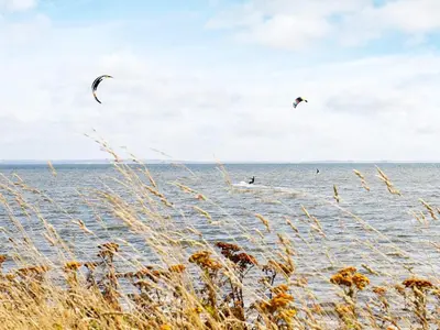 two kites flying over a body of water at 10 person holiday home in Vestervig-By Traum in Vestervig