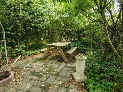 a picnic table and a fire hydrant in a forest at 6 person holiday home in Struer-By Traum in Struer