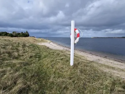 a white pole on the side of a beach at 6 person holiday home in Højslev-By Traum in Højslev
