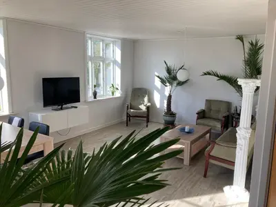 a living room with a flat screen tv and a couch at Idyllic country house in Vadum