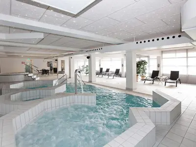 a large pool with a hot tub in a building at 4 person apartment in holiday park Blokhus in Blokhus