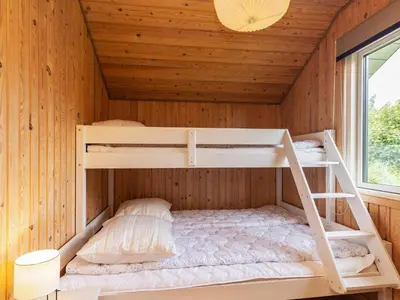 a room with two bunk beds in a cabin at 8 person holiday home in Højslev-By Traum in Højslev