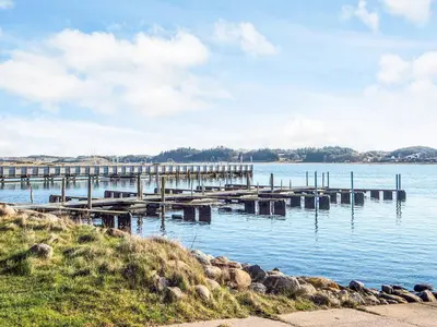 a dock on a body of water with rocks in the water at 8 person holiday home in Højslev-By Traum in Højslev