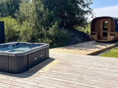 a hot tub sitting on top of a wooden deck at 20 person holiday home in Højslev-By Traum in Højslev