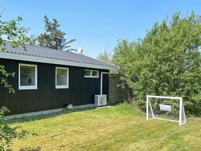 a house with a soccer goal in the yard at 6 person holiday home in Thyholm-By Traum in Thyholm