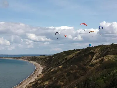 a bunch of kites flying in the sky over the ocean at 8 person holiday home in Struer-By Traum in Struer