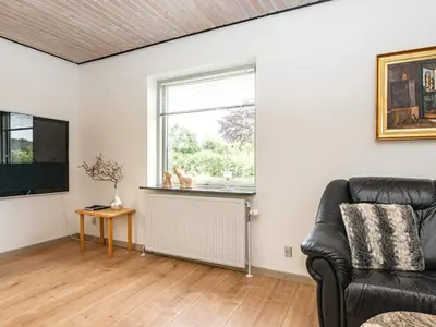 a living room with a couch and a window at 8 person holiday home in Struer-By Traum in Struer