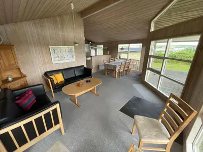 a living room with a couch and a table at Ældre Sommerhus Max 4 voksne og 4 børn in Lemvig