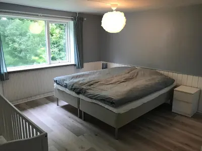 a bedroom with a bed and a window at Sommerhus på Mors in Øster Assels