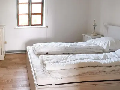 two white beds in a room with a window at 8 person holiday home in Vesløs-By Traum in Vesløs