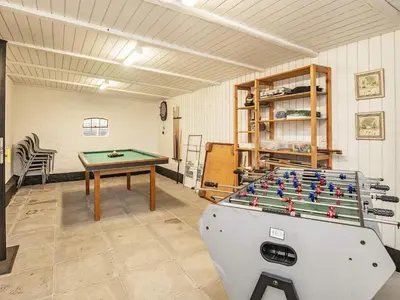 a room with a ping pong table and a pool table at 10 person holiday home in Roslev-By Traum in Roslev