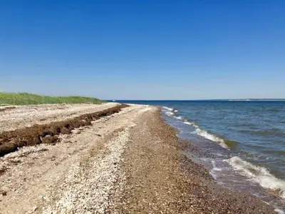 a rocky beach with the ocean in the background at 10 person holiday home in Roslev-By Traum in Roslev