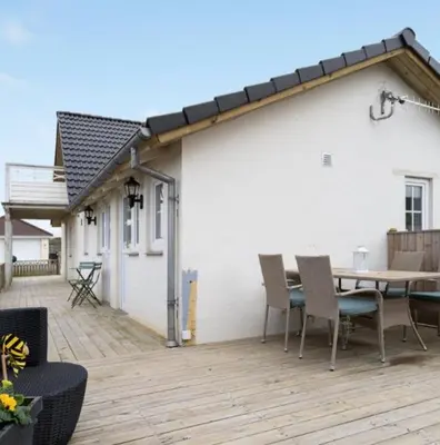 a patio with a table and chairs on a deck at Cold Hawaii in Torsted