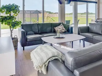 a living room with a couch and a table at Luxury Retreat by Limfjorden - By Traum Ferienwohnungen in Spottrup