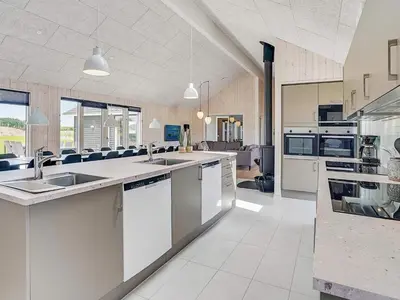 a large kitchen with white counters and appliances at Luxury Retreat by Limfjorden - By Traum Ferienwohnungen in Spottrup