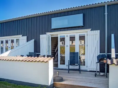 a house with a deck with a large screen on it at 6 person holiday home in Vestervig-By Traum in Vestervig