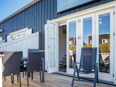 a patio with a table and chairs on a deck at 6 person holiday home in Vestervig-By Traum in Vestervig