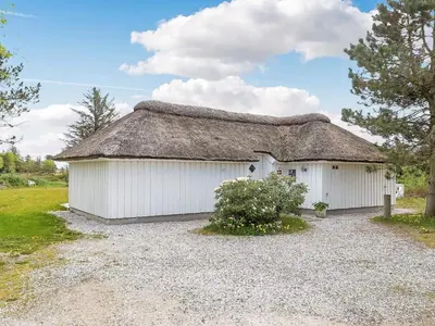 a large white building with a thatched roof at 10 person holiday home in Fjerritslev-By Traum in Fjerritslev