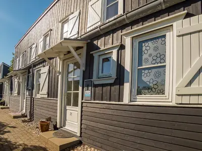 a building with a door and windows on a street at 6 person holiday home in Vestervig-By Traum in Vestervig