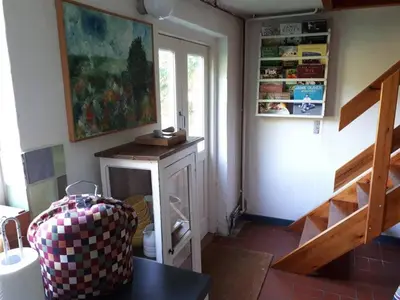 a room with a staircase and a table and a painting at Glædegården -Glaede Landhof- 12 beds! in Frøstrup