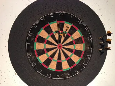 a dartboard on a table with some darts at Glædegården -Glaede Landhof- 12 beds! in Frøstrup