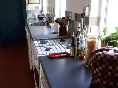 a kitchen counter with a stove and a sink at Glædegården -Glaede Landhof- 12 beds! in Frøstrup