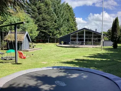 a park with a building and a frisbee at 8 person holiday home in Blokhus-By Traum in Blokhus