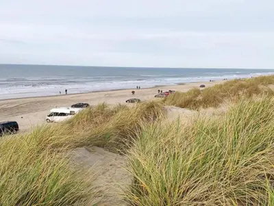 a group of cars parked on a beach at 8 person holiday home in Blokhus-By Traum in Blokhus