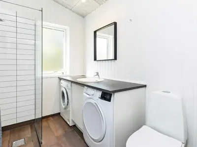 a bathroom with a washing machine and a sink at 10 person holiday home in Fjerritslev-By Traum in Fjerritslev