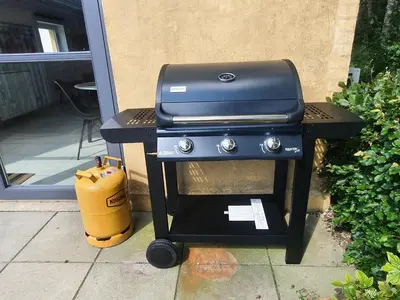 a grill sitting on a table next to a patio at Airbnb-lejligheder, Villerslev in Villerslev