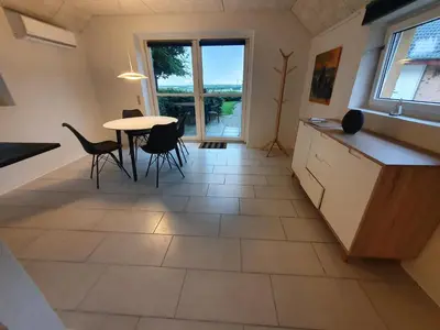 a kitchen and dining room with a table and chairs at Airbnb-lejligheder, Villerslev in Villerslev