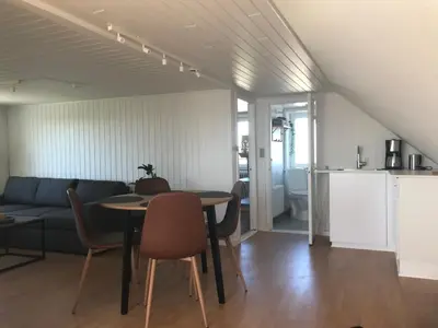 a living room with a table and a couch at Seaside Top in Thisted