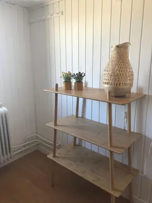 a shelf with a vase and potted plants on it at Seaside Top in Thisted