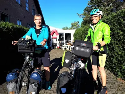 a man and a woman standing next to their bikes at Thisted Øst Bed & No Breakfast in Thisted