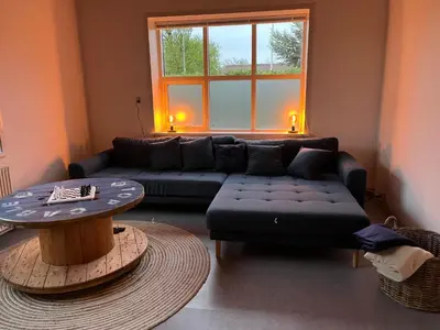 a living room with a couch and a table at Room 6 - Hawkraft Kulturhotel in Vestervig