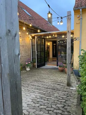 an entrance to a building with lights on it at Room 5 - Hawkraft kulturhotel in Vestervig