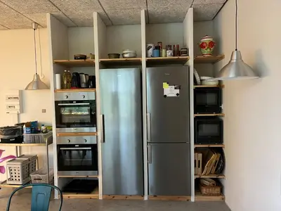 a kitchen with a stainless steel refrigerator at Room 5 - Hawkraft kulturhotel in Vestervig