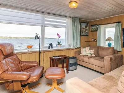 a living room with a couch and a chair at 4 person holiday home in Farsø-By Traum in Farsø