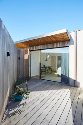 a deck with a sliding glass door to a dining area at Vesterlandet in Vestervig