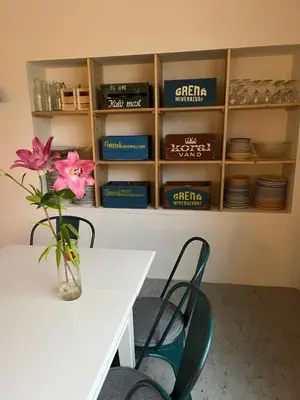 a table and chairs with a vase of flowers on a table at Room 16 - Hawkraft kulturhotel in Vestervig