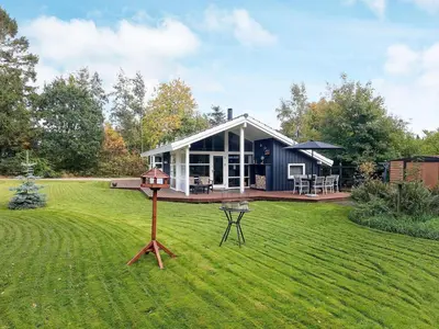 a house on a lawn with a grill in the yard at 6 person holiday home in Farsø-By Traum in Farsø