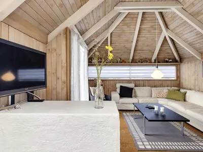 a living room with a couch and a tv at 8 person holiday home in Fjerritslev-By Traum in Fjerritslev