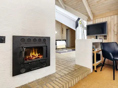 a living room with a fireplace and a tv at 8 person holiday home in Fjerritslev-By Traum in Fjerritslev