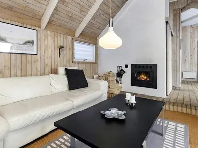 a living room with a white couch and a fireplace at 8 person holiday home in Fjerritslev-By Traum in Fjerritslev