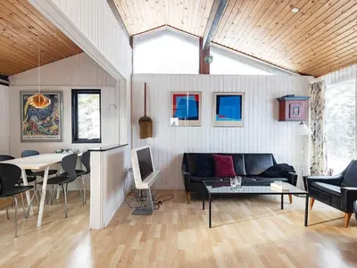 a living room with a couch and a table at 6 person holiday home in Saltum-By Traum in Saltum