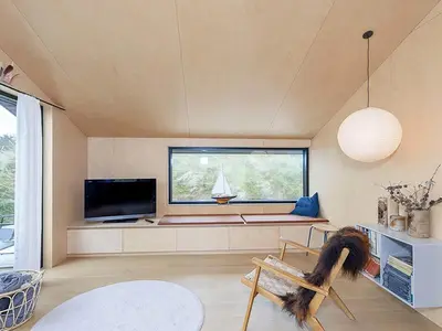 a living room with a bench and a tv at 6 person holiday home in Saltum-By Traum in Saltum