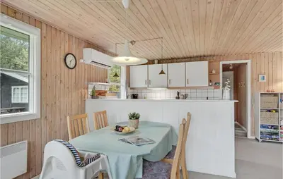 a kitchen and dining room with a table and chairs at 3 Bedroom Awesome Home In Saltum in Saltum